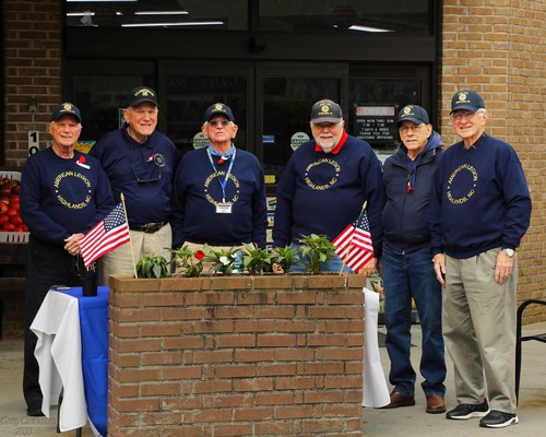 Post 370 Legionnaires giving away poppies at Bryson's Grocery.